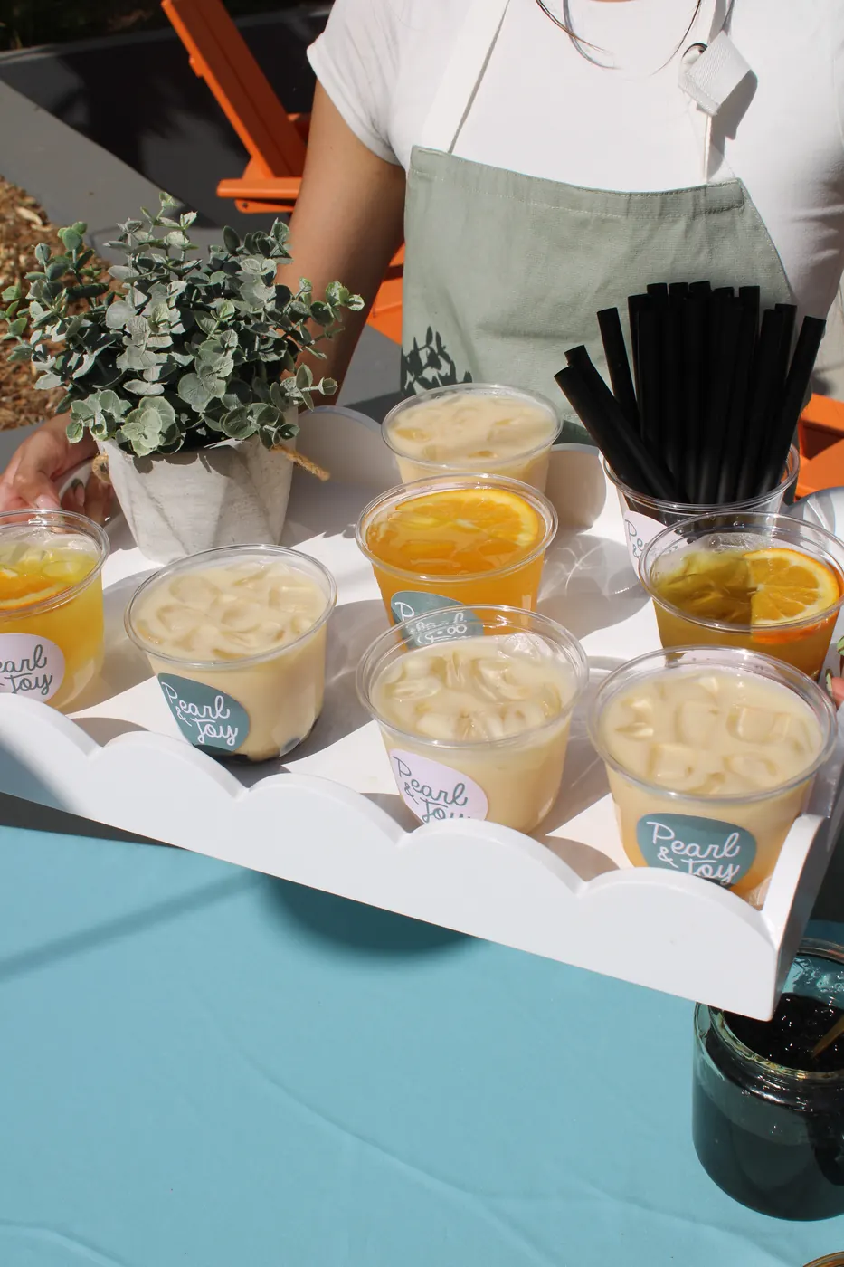 Tray of Pearl & Joy mango passion and jasmine milk tea drinks