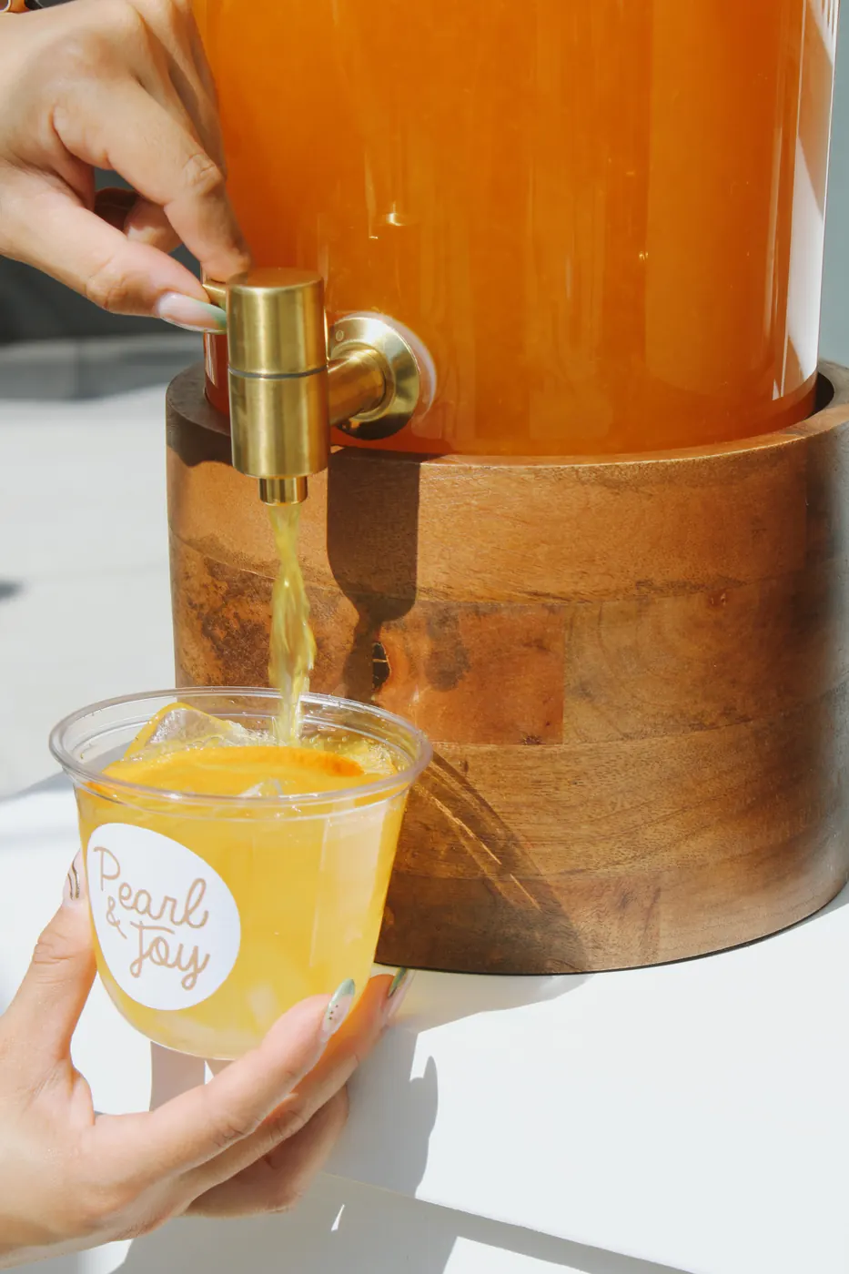 Mango passion green tea poured into a Pearl & Joy cup