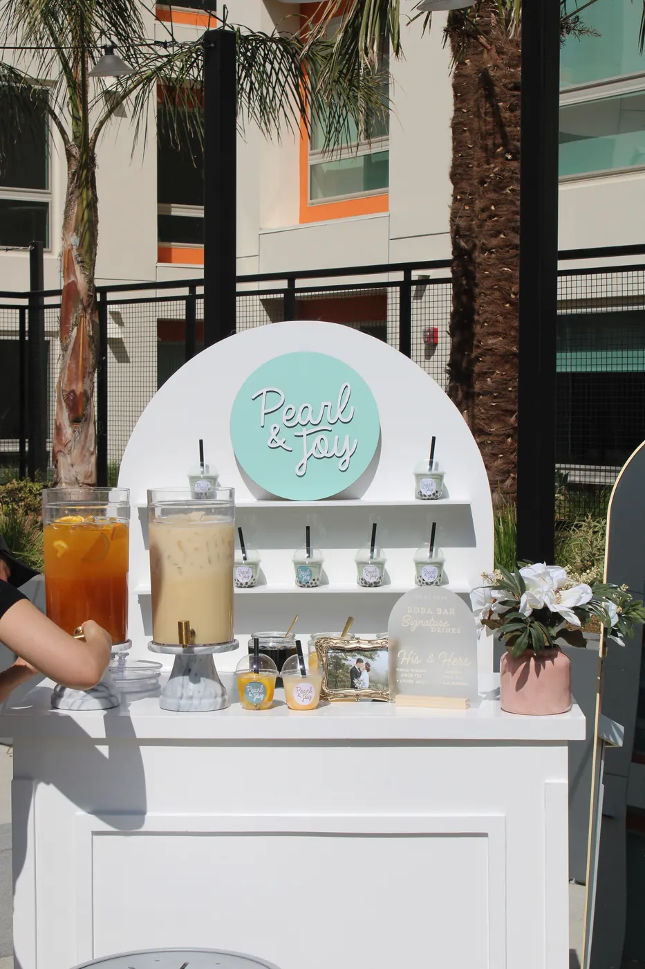 Pearl & Joy mobile boba bar display with drink dispensers and wedding details